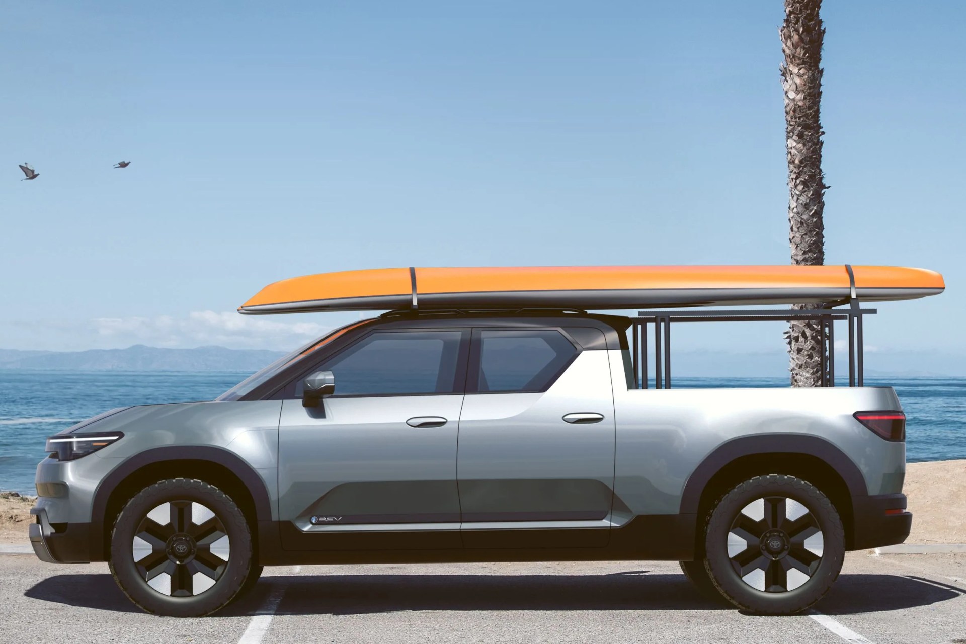 toyota electric pickup with surfboard on the roof