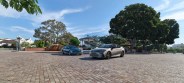 two cars parked on a brick road