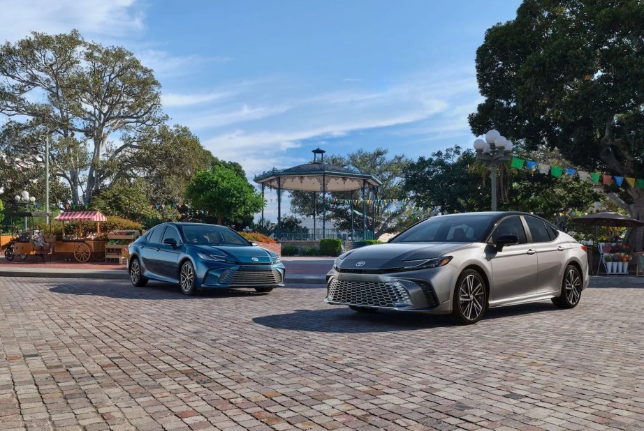 two cars parked on a brick road