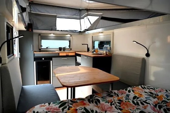 a trailer interior with a table and chairs