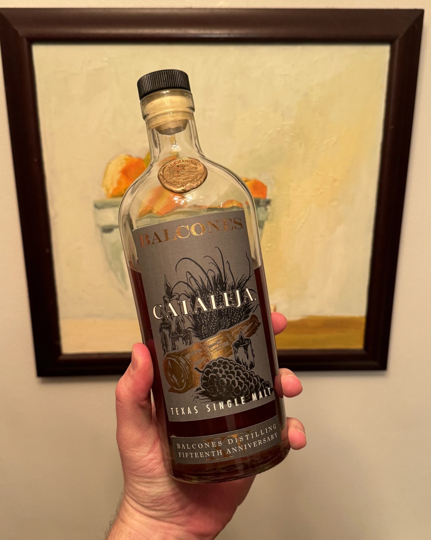 hand holding bottle of whiskey