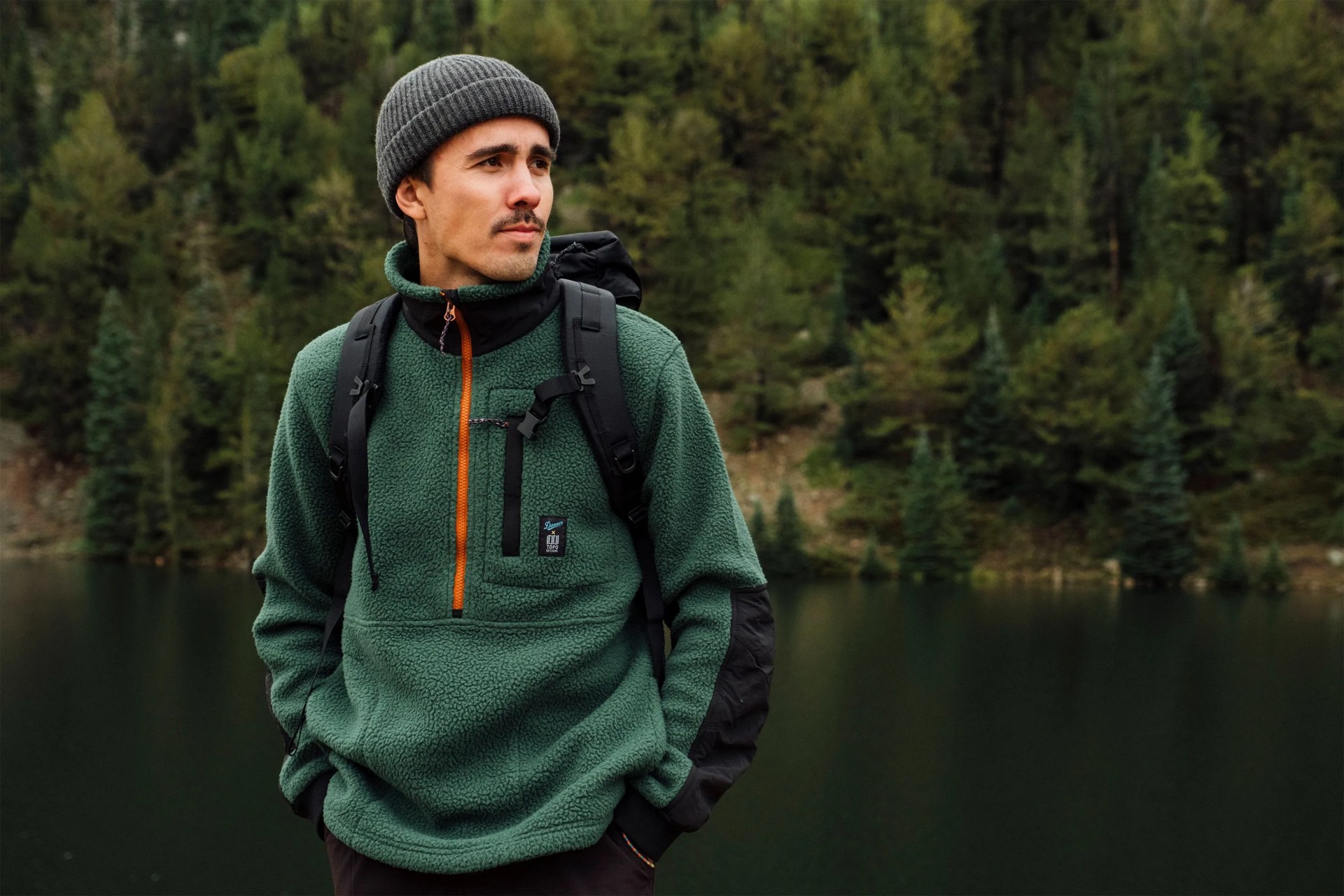 a man standing by a lake