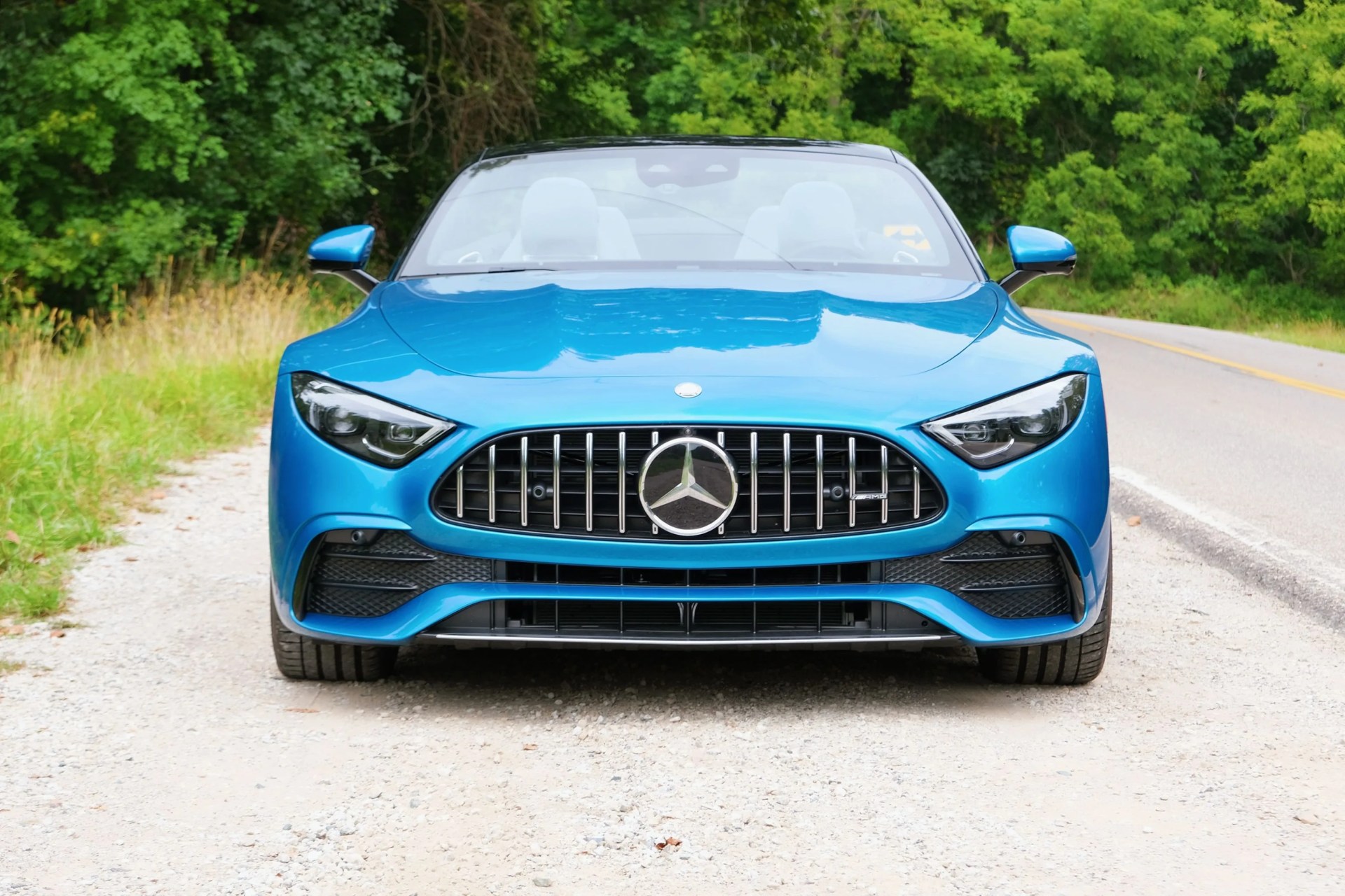 a blue car on a road