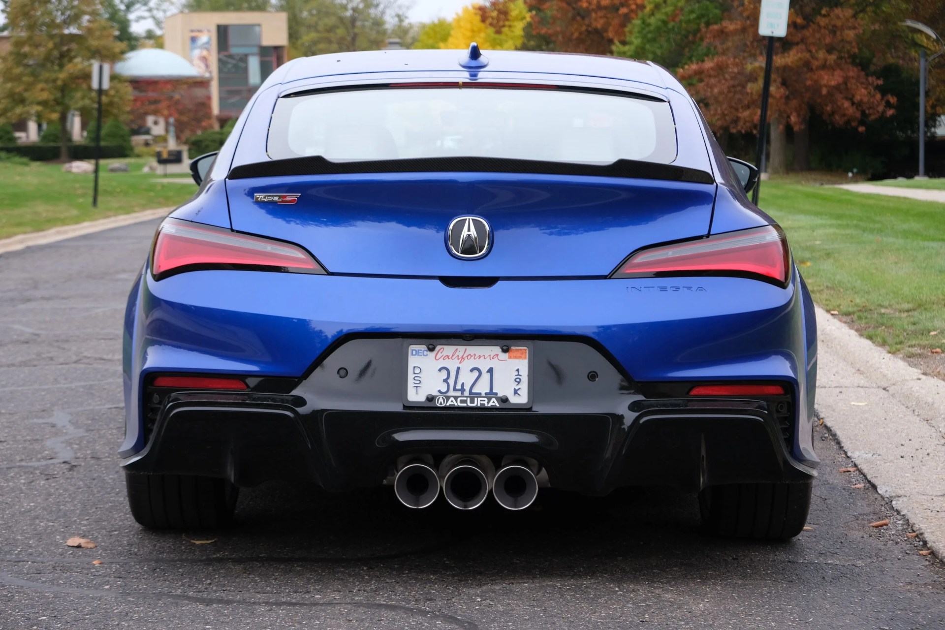 a blue car parked on the side of a road