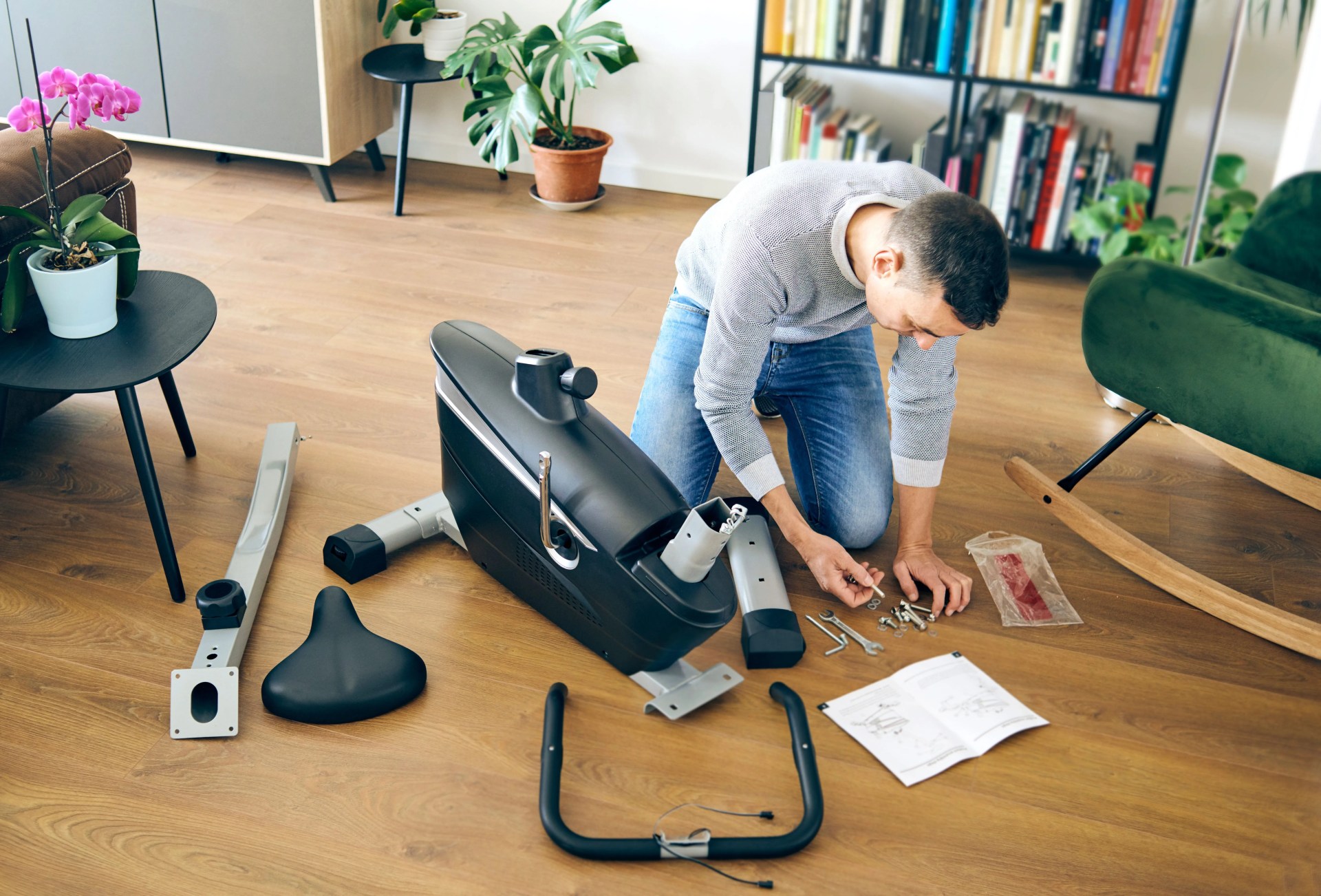 a man putting an exercise bike together