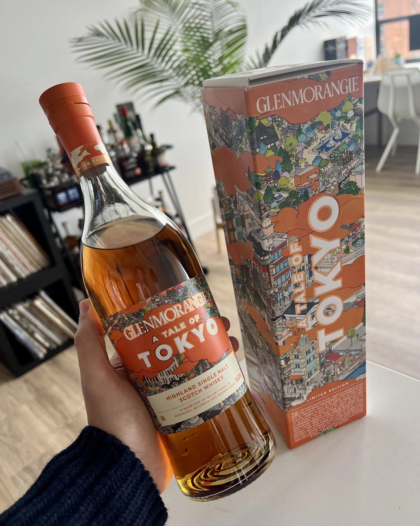 bottle of scotch in hand
