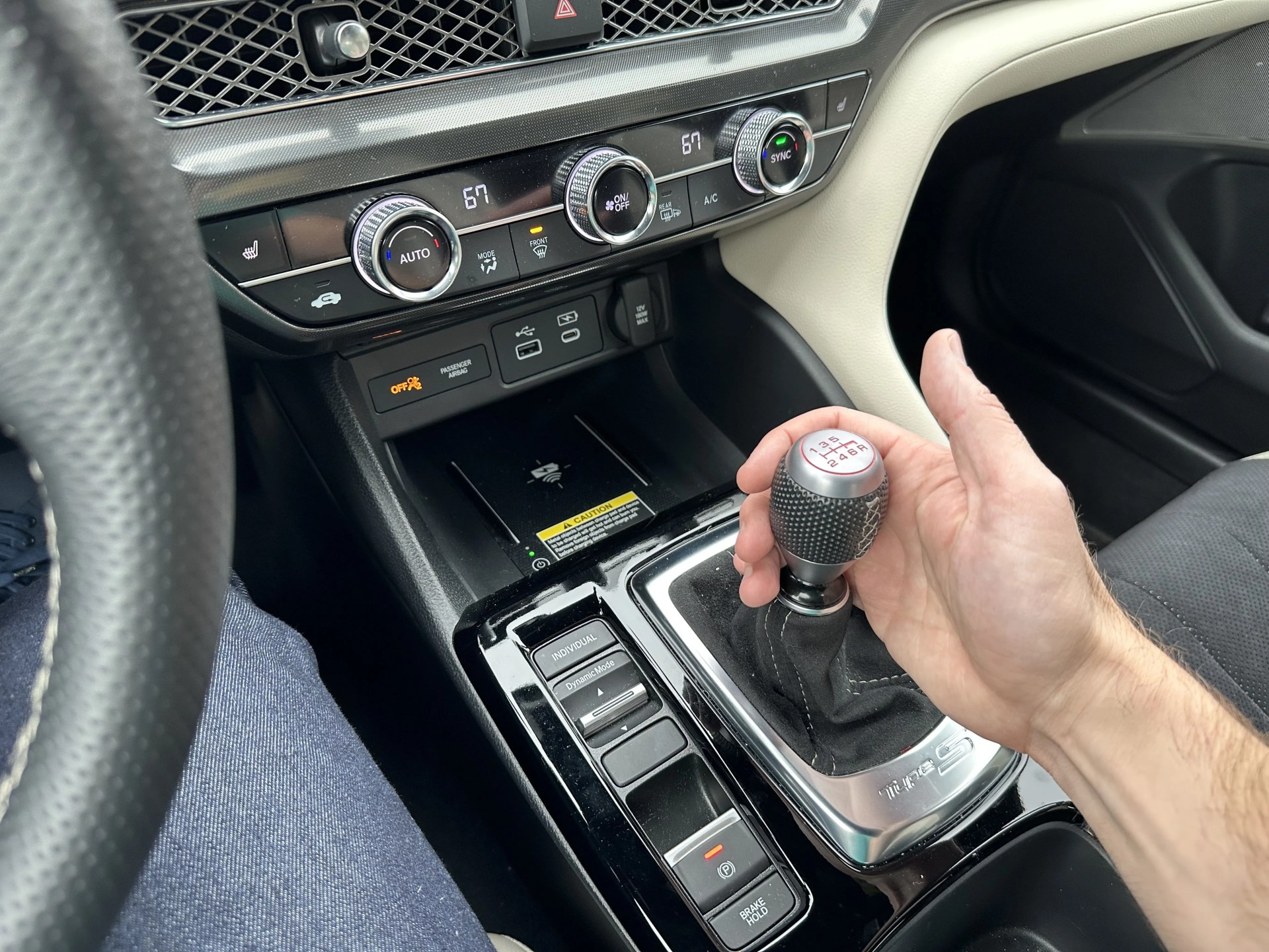 a hand holding the shfit knob in the integra type s