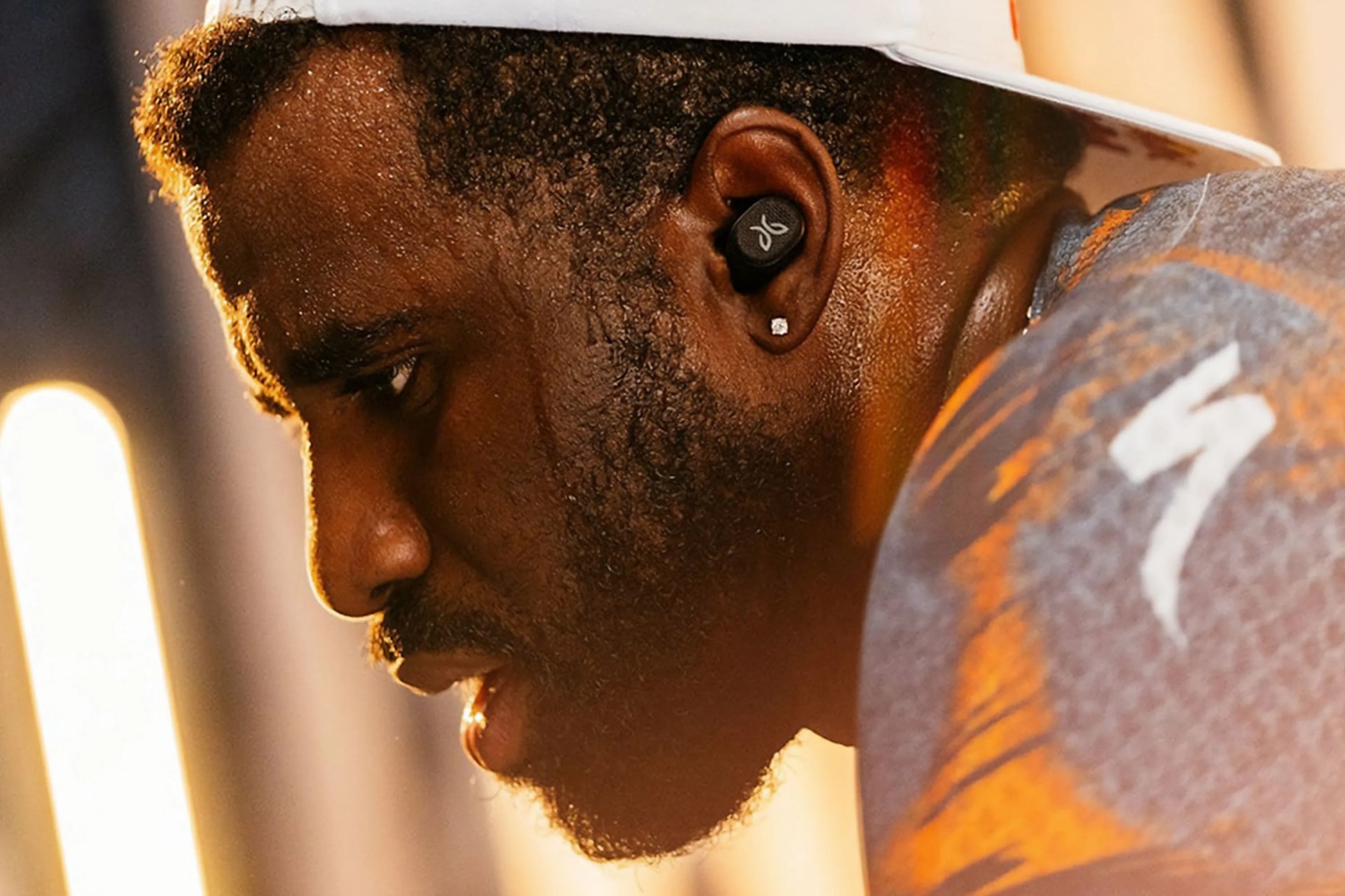 a man wearing earbuds while working out