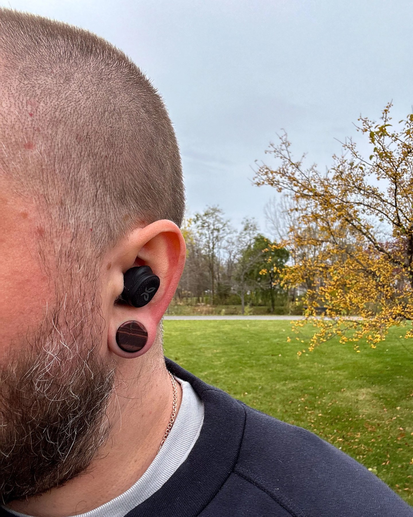 a man outside wearing ear buds