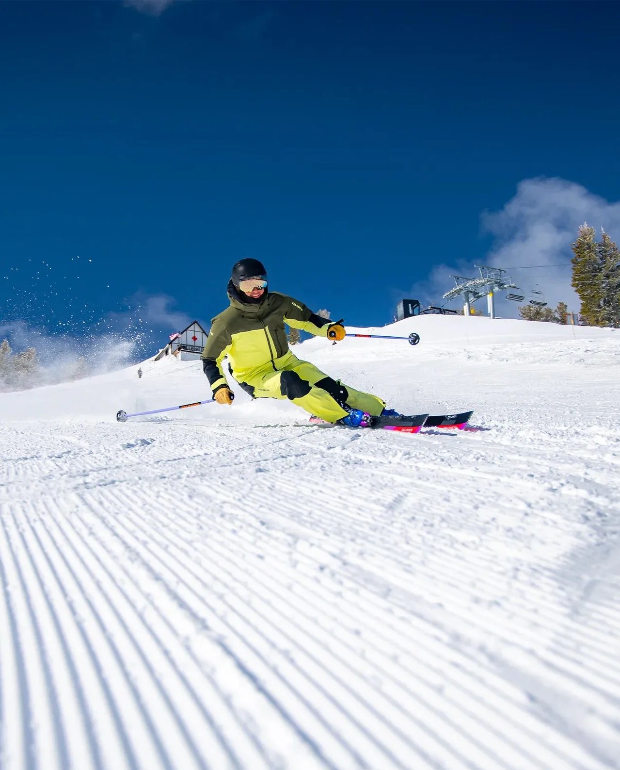 a person skiing down a slope wearing salomon moon patrol gore tex men's shell jacket