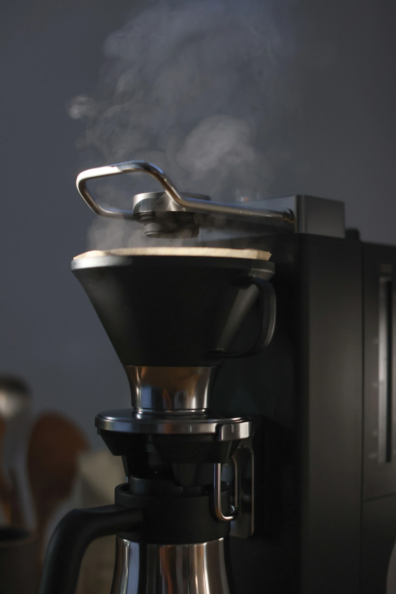 close up of a coffee maker making steam