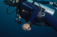 a person in a diving suit wearing a watch