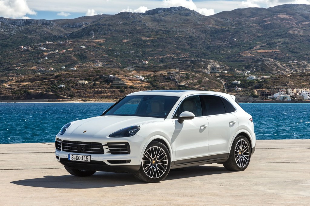 a porsche cayenne parked by water