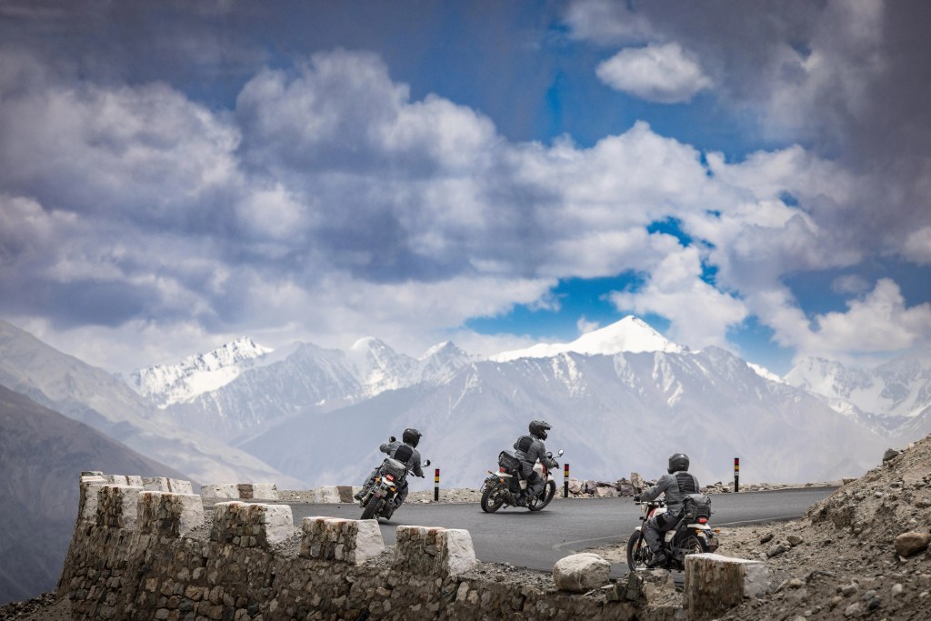 people riding motorcycles down a mountain