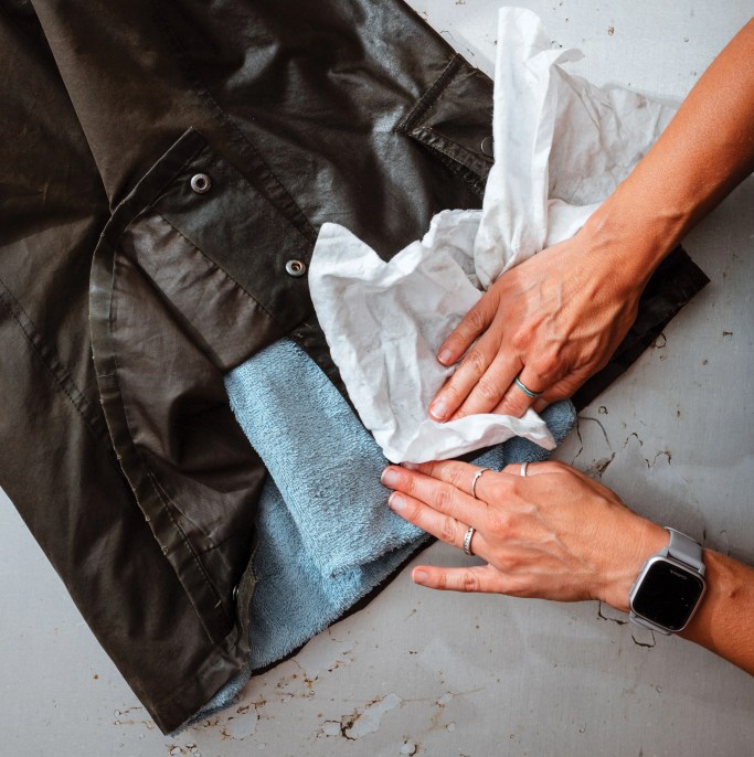 a woman cleaning a jacket