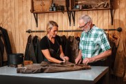 a father and daughter restoring a waxed leather jacket