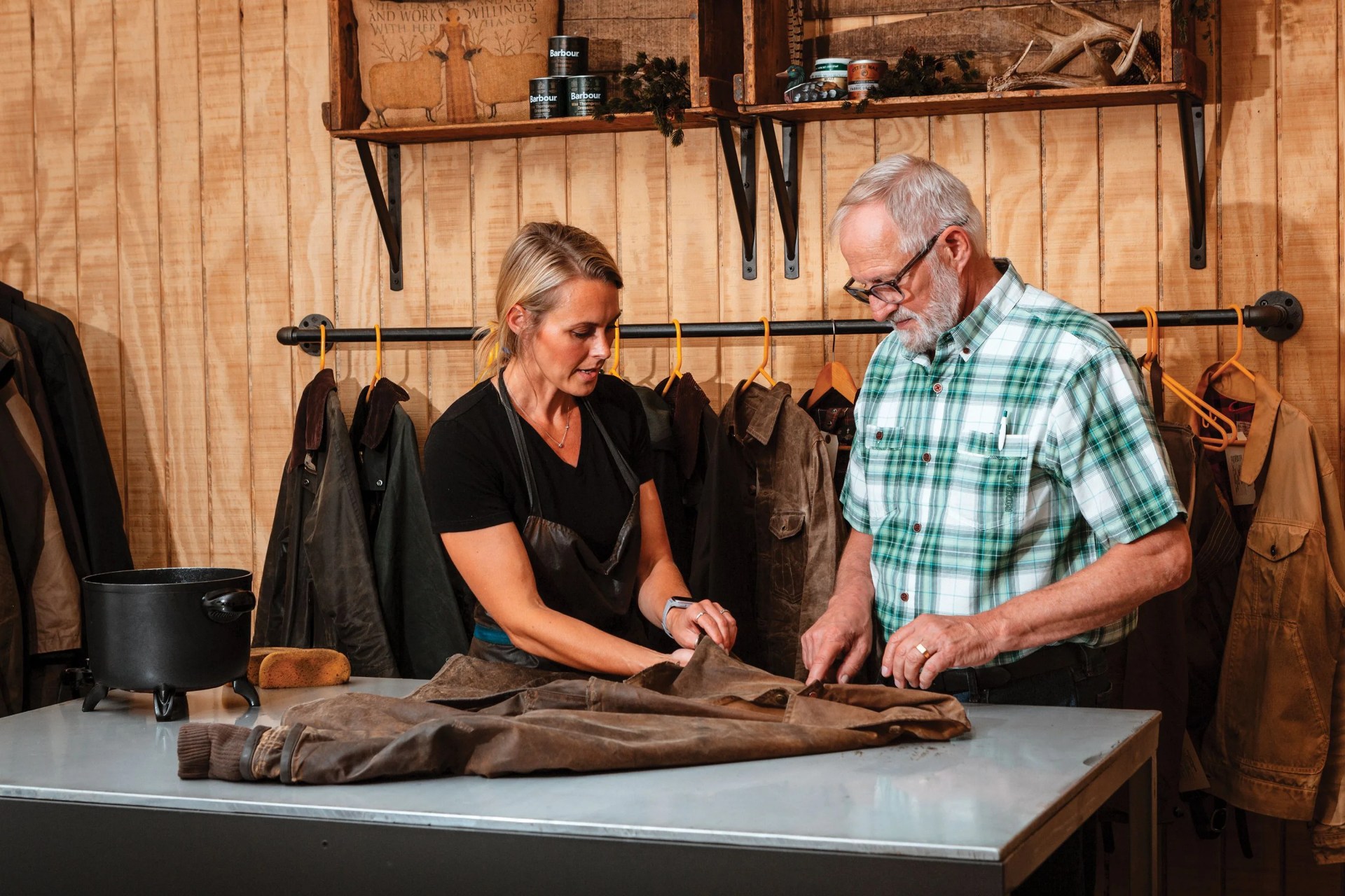 a father and daughter restoring a waxed leather jacket
