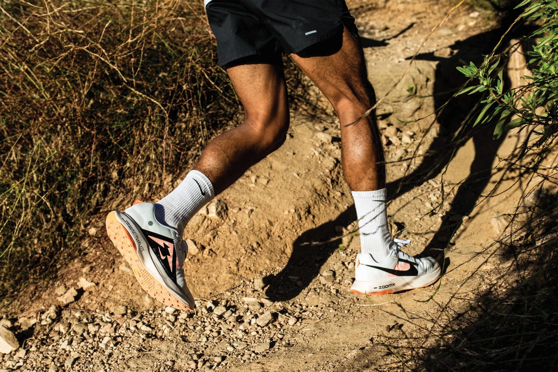 a man running on a dirt trail