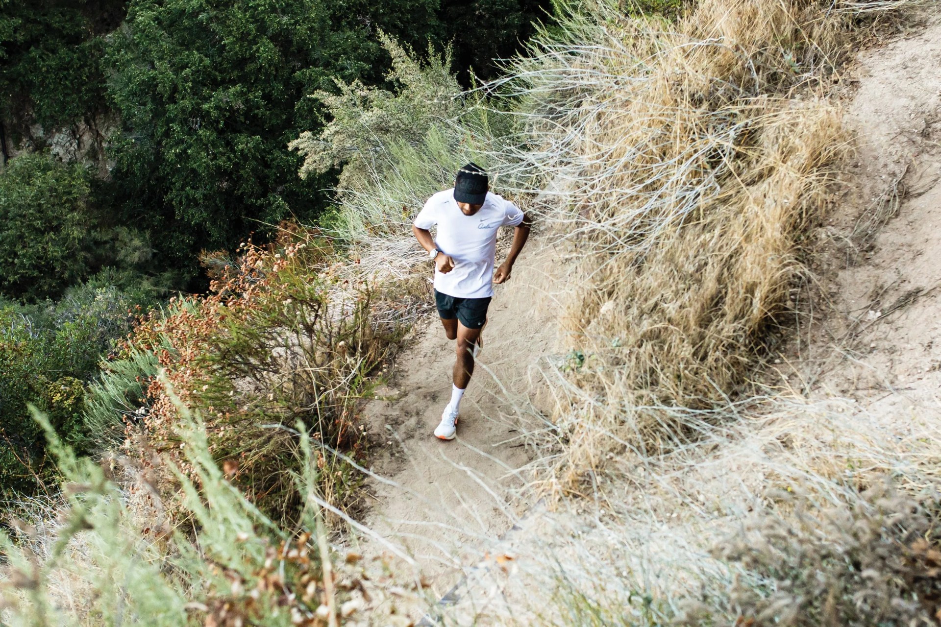 a man running on a dirt trail