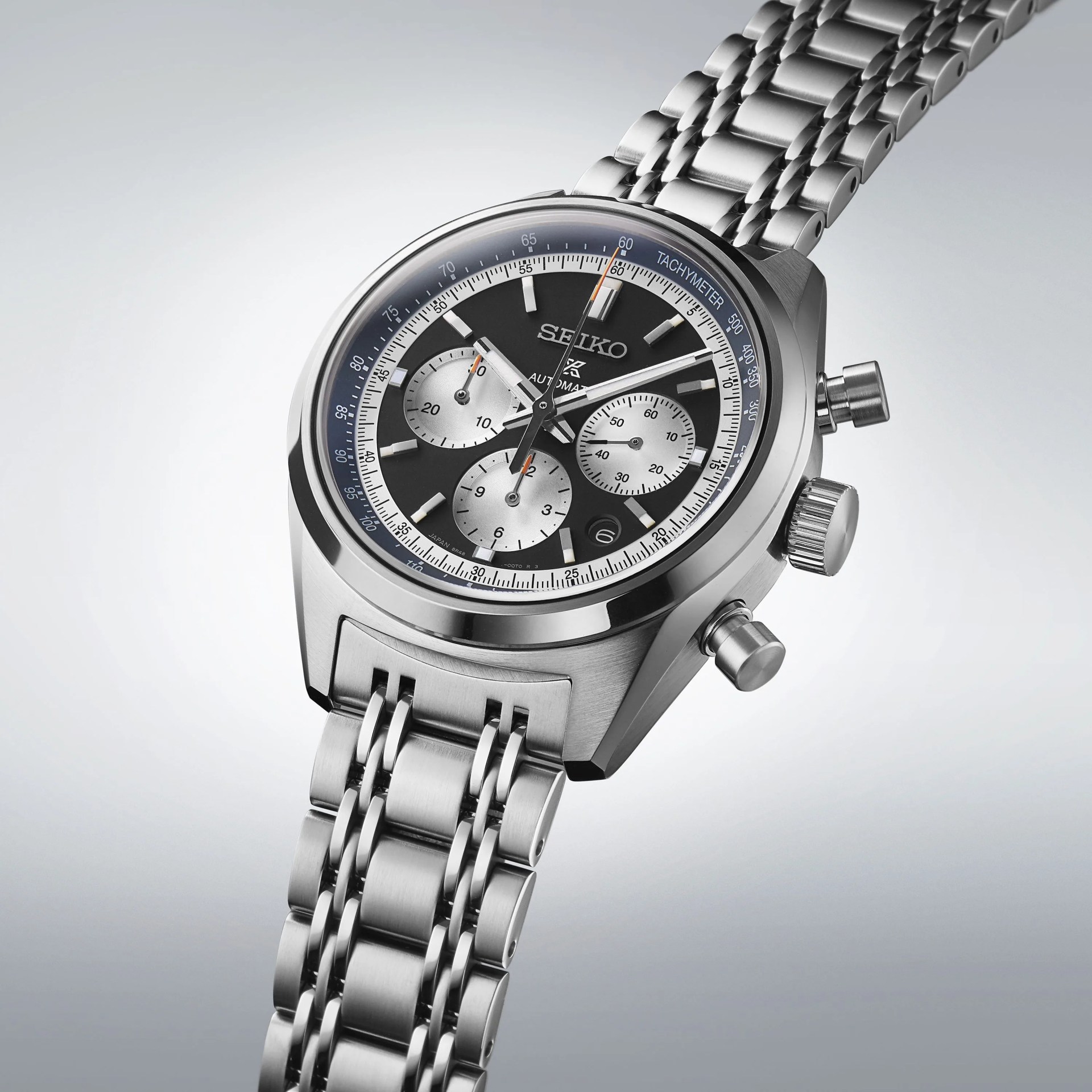 a silver watch with a black face