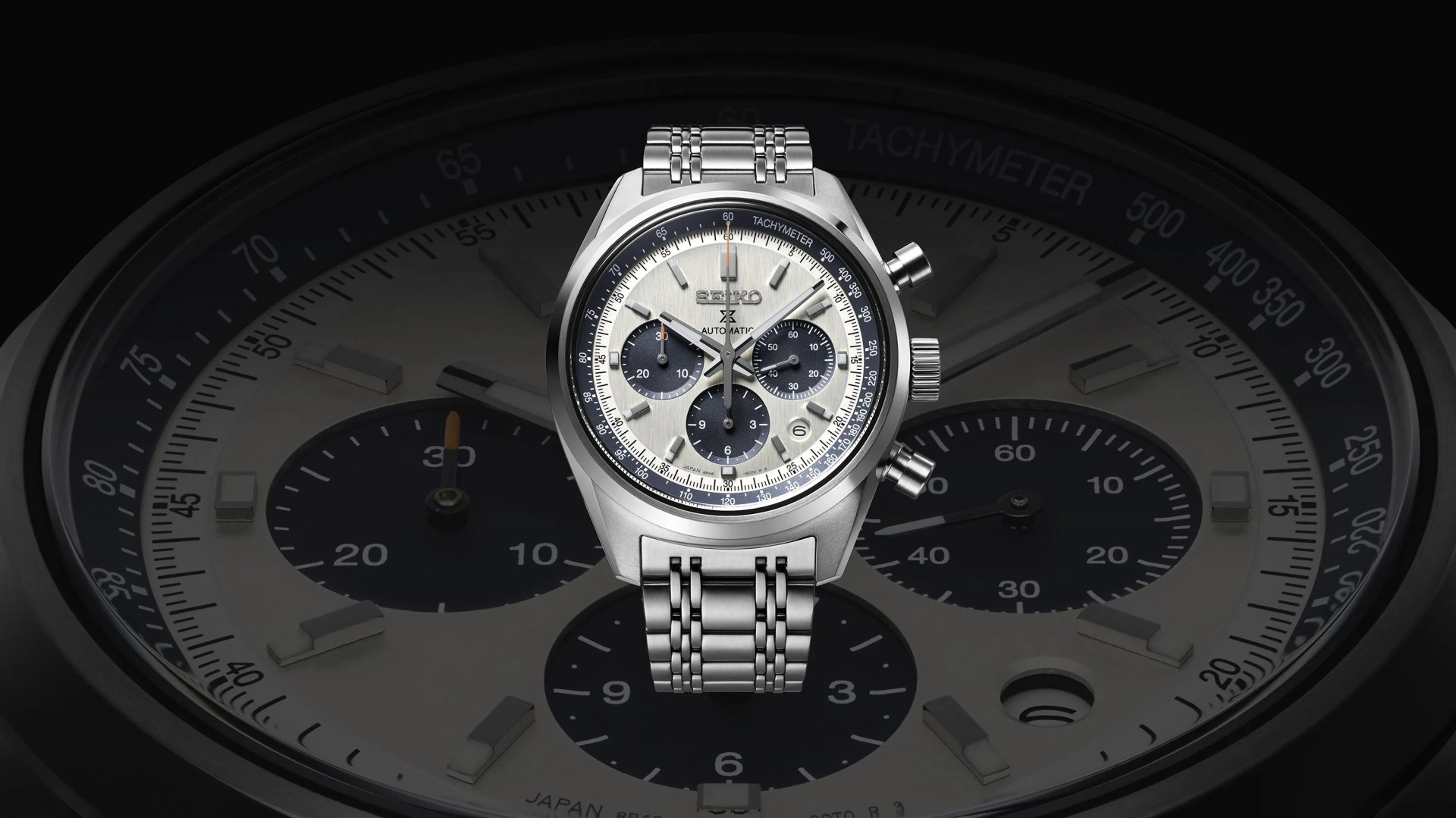 a silver watch with a black face