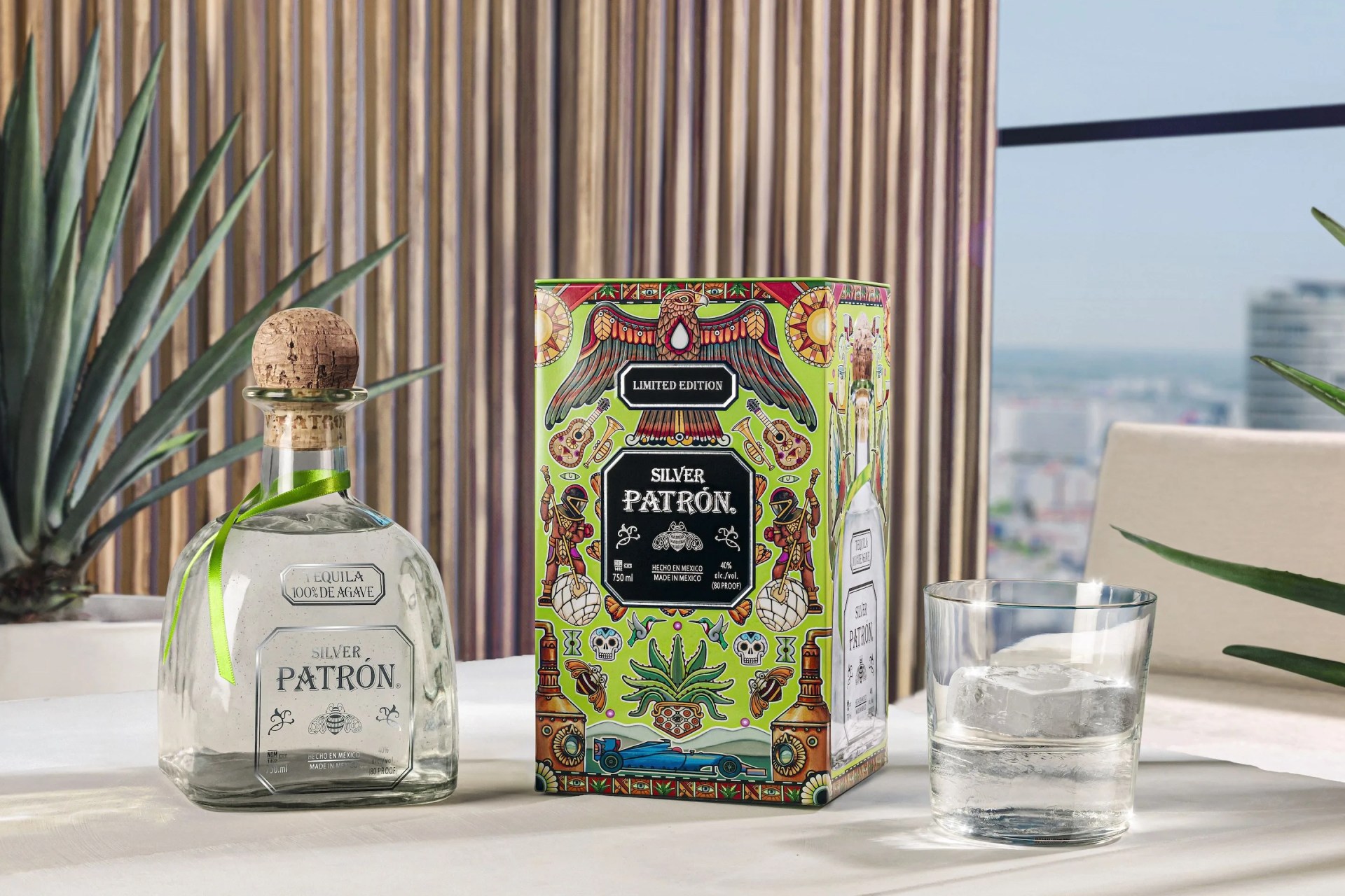a bottle of perfume and a glass on a table