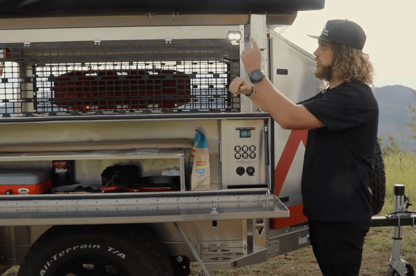 a person standing next to a large truck with a lot of items in it
