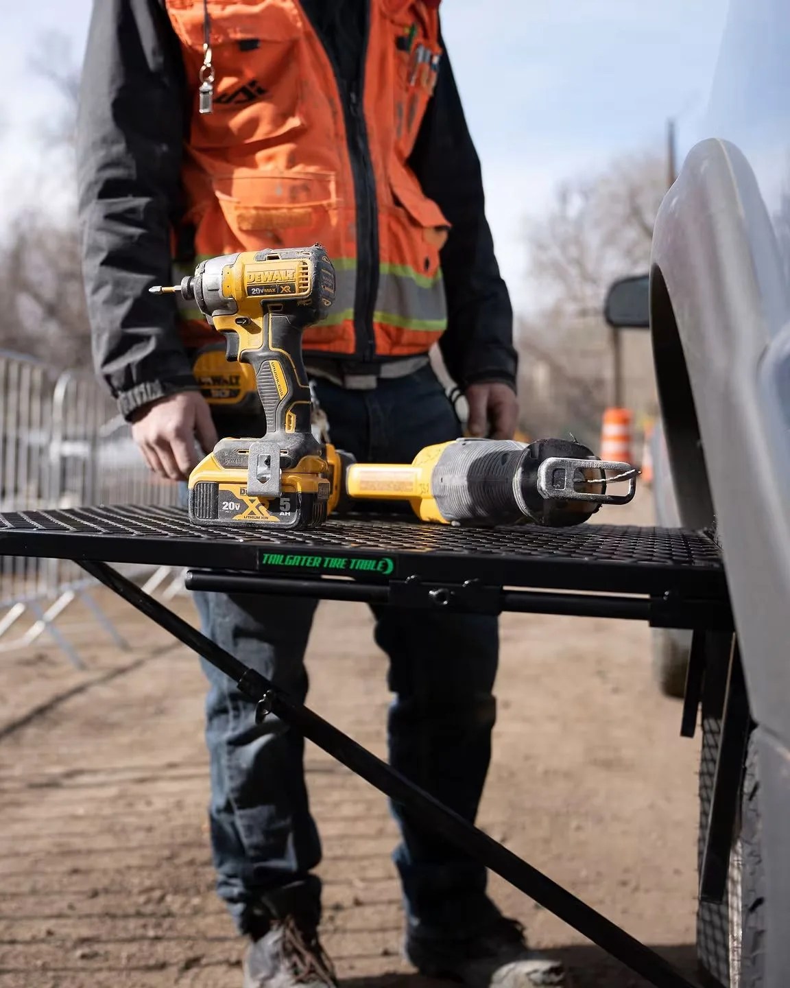 a person standing by tailgater tire table aluminum tire table