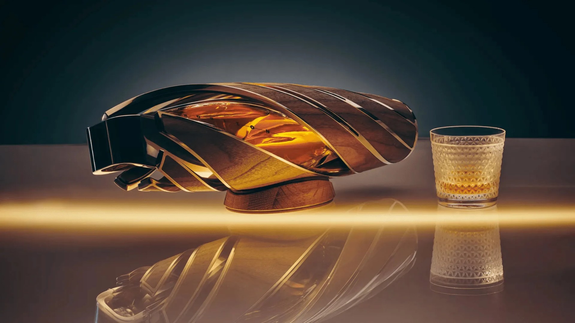the macallan and bentley motors the horizon scotch whisky bottle on its side with a glass next to it