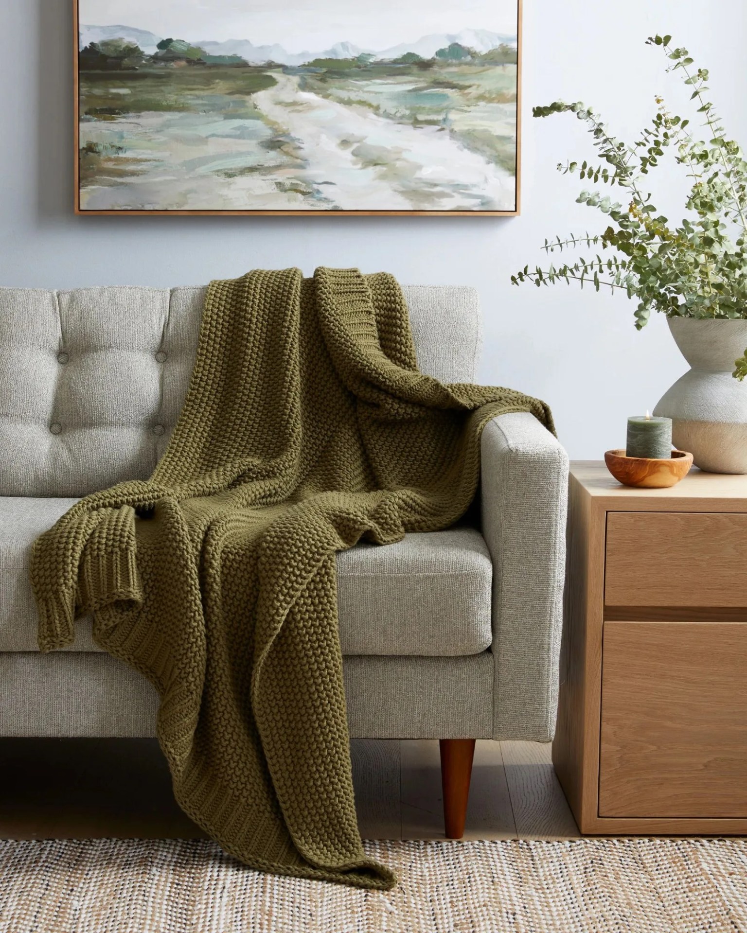 a quince cotton fisherman throw on a couch