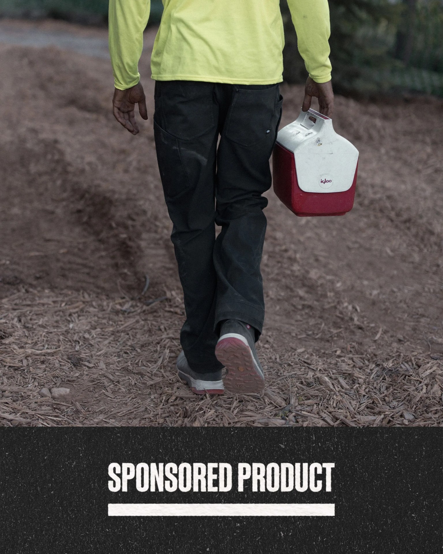 sponsored product man wearing 686 work pants holding lunch pail
