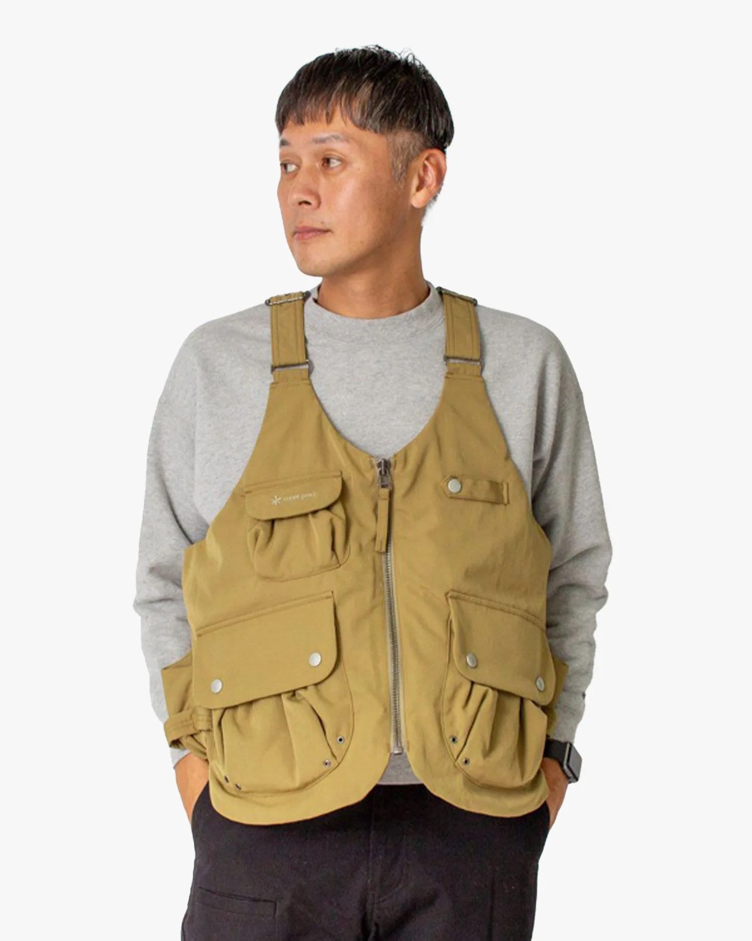 a man wearing snow peak 65th anniversary takibi down vest