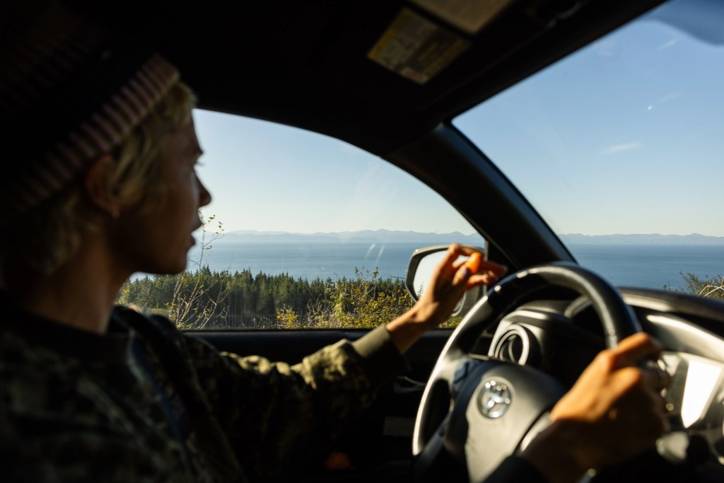 hanna scott driving car looking out at forrest