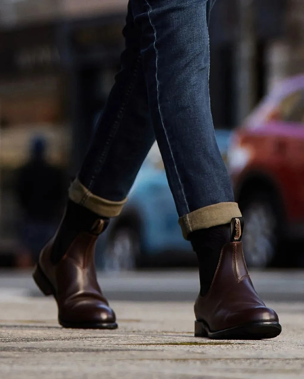 a person walking wearing blundstone chelsea boots