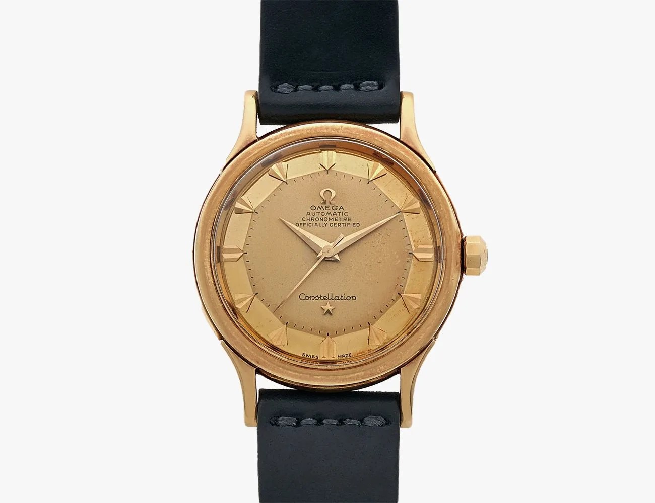 a gold watch with a black band