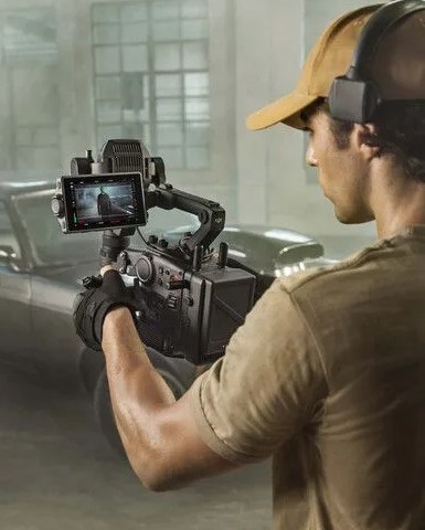 a person wearing a helmet and holding a dji ronin 4d 4 axis cinema camera