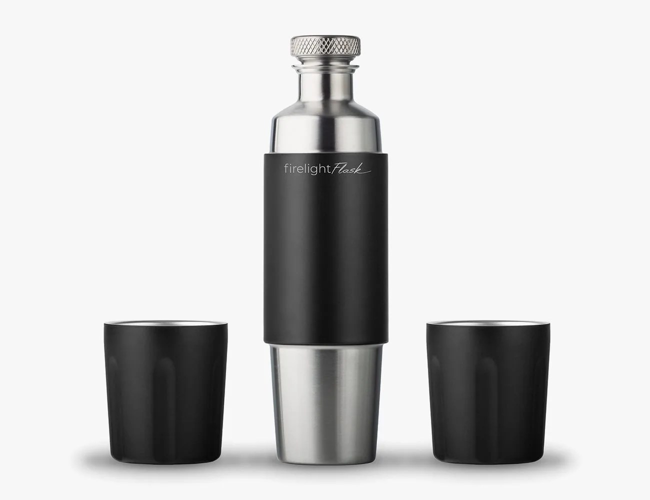 a flask with shot glasses