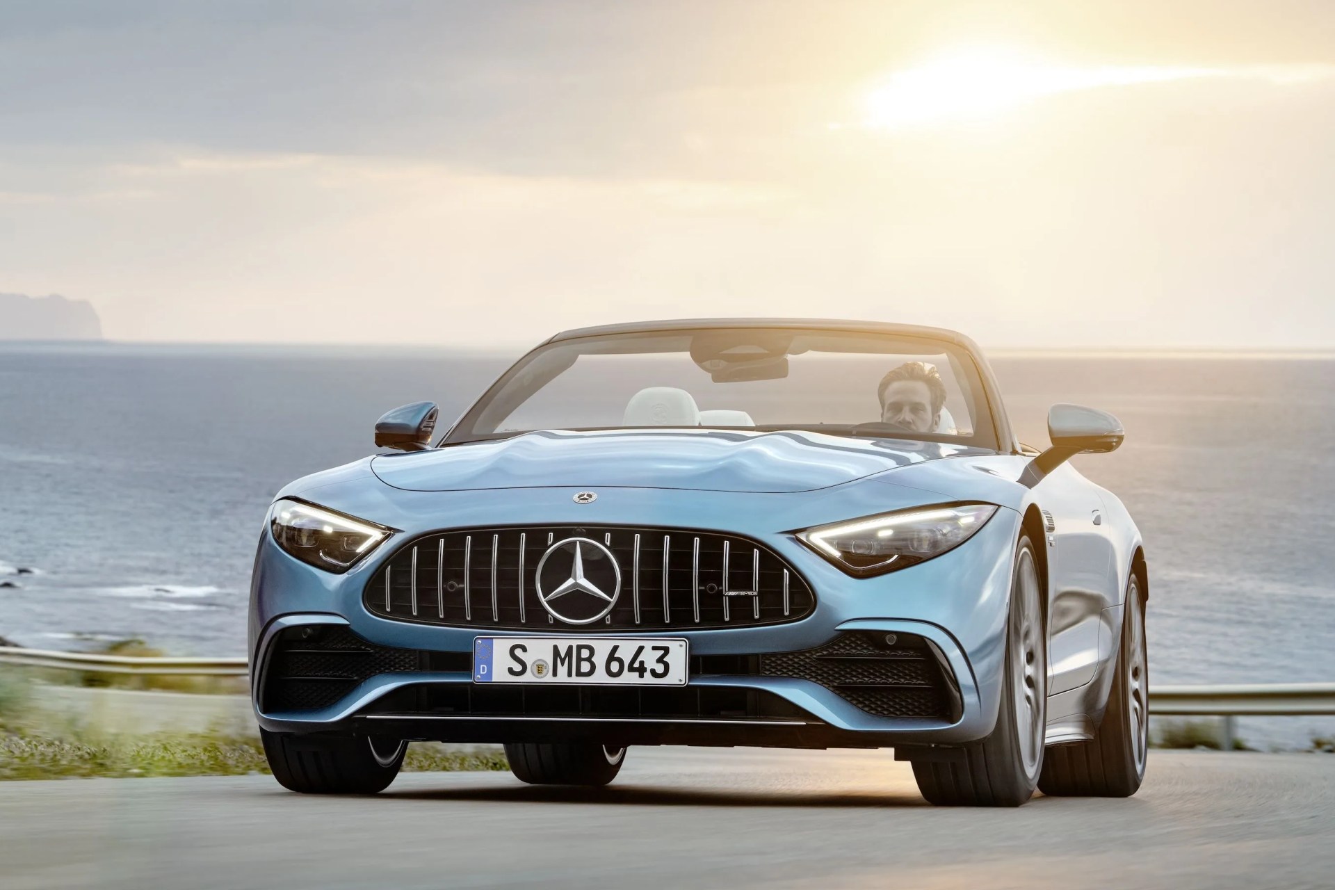 mercedes amg sl 43 roadster driving down sunny coastal highway