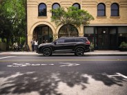 a black car parked on the side of a street