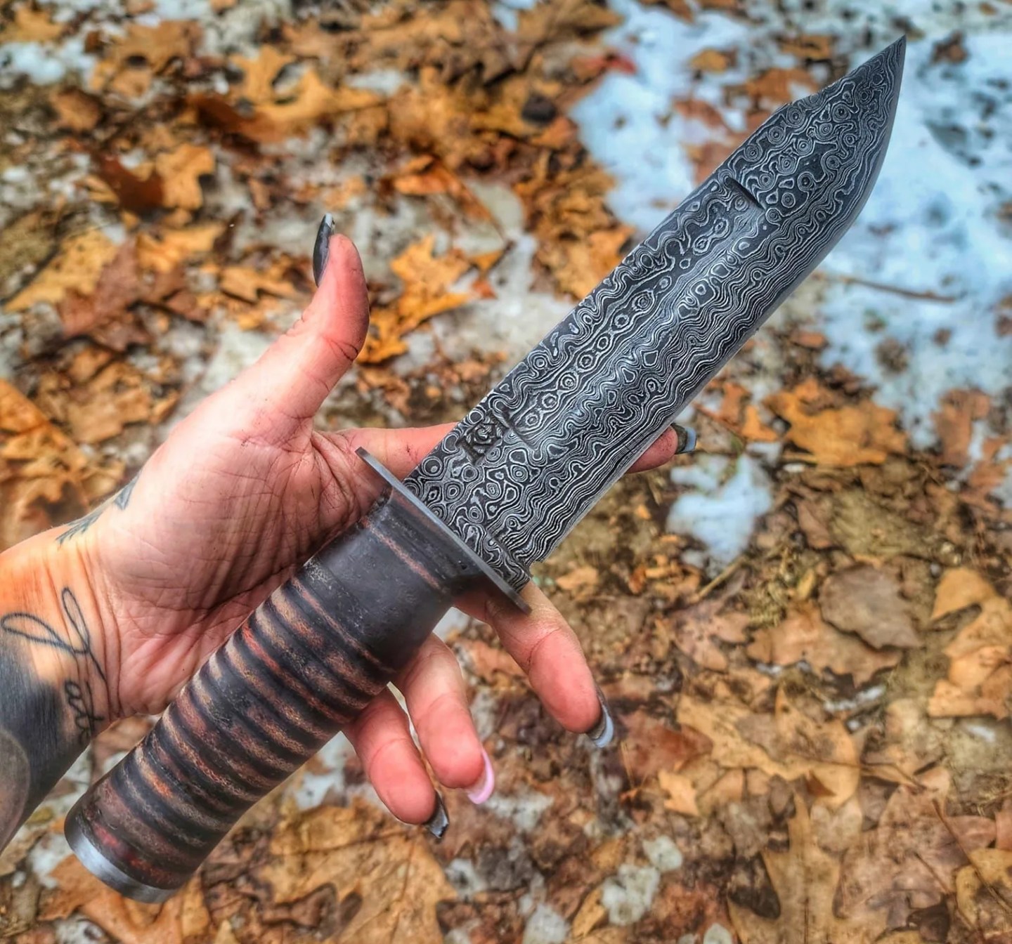 a hand holding a knife