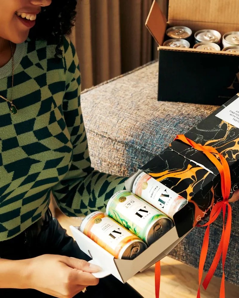 a person holding a box of af drinks