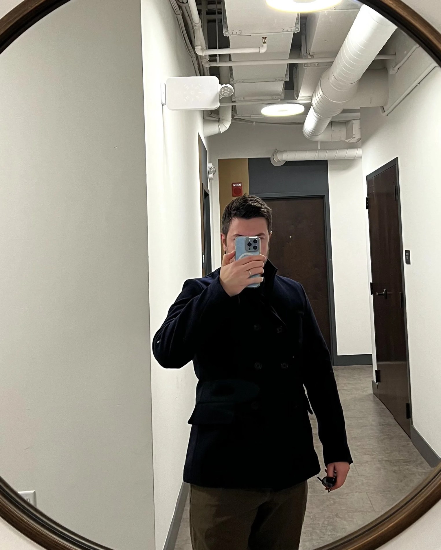 a person taking a selfie in a hallway