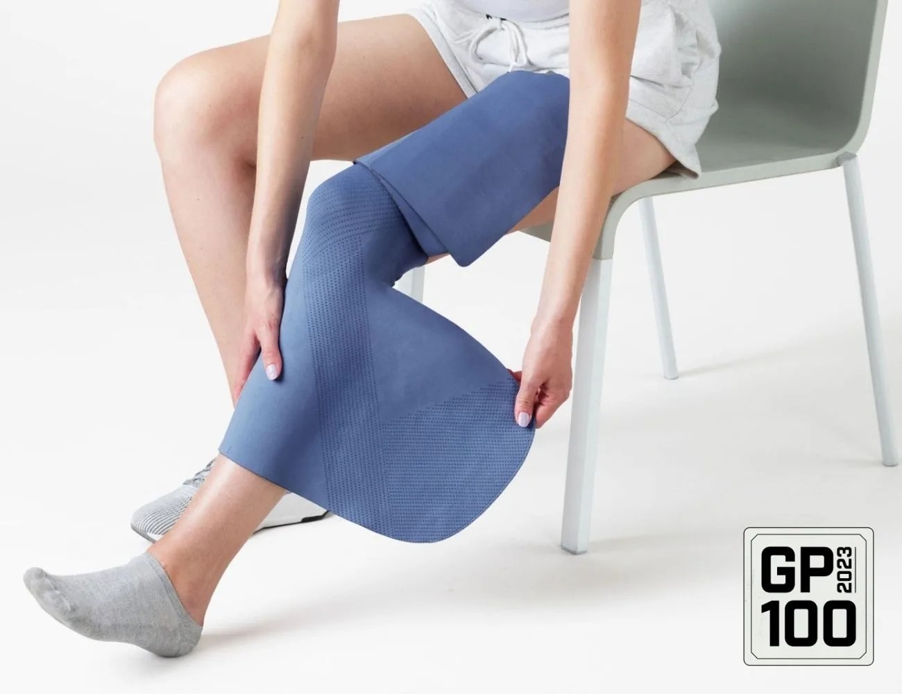 a woman using a neural sleeve on her leg