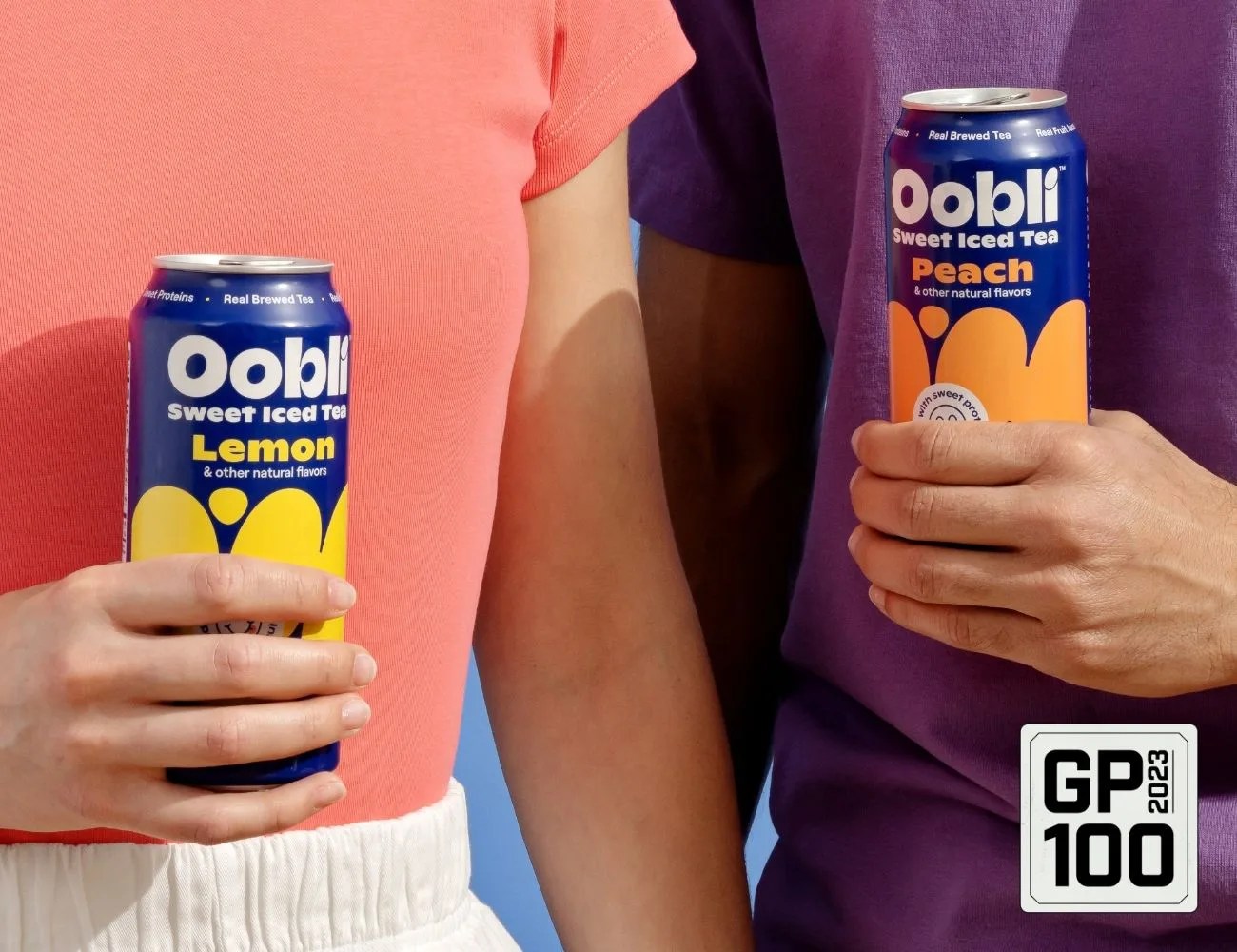 a person holding two cans