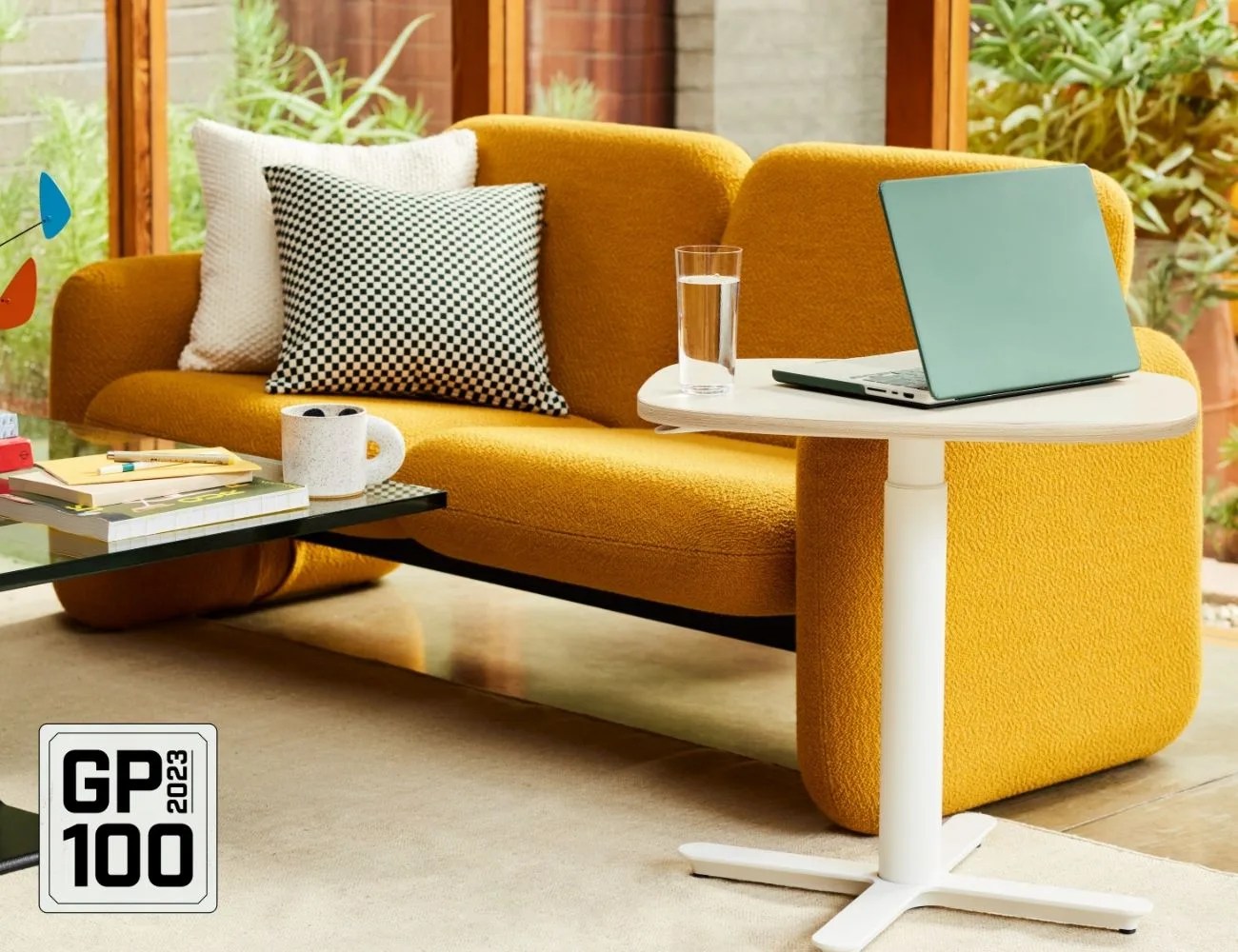a laptop on a coffee table next to a sofa