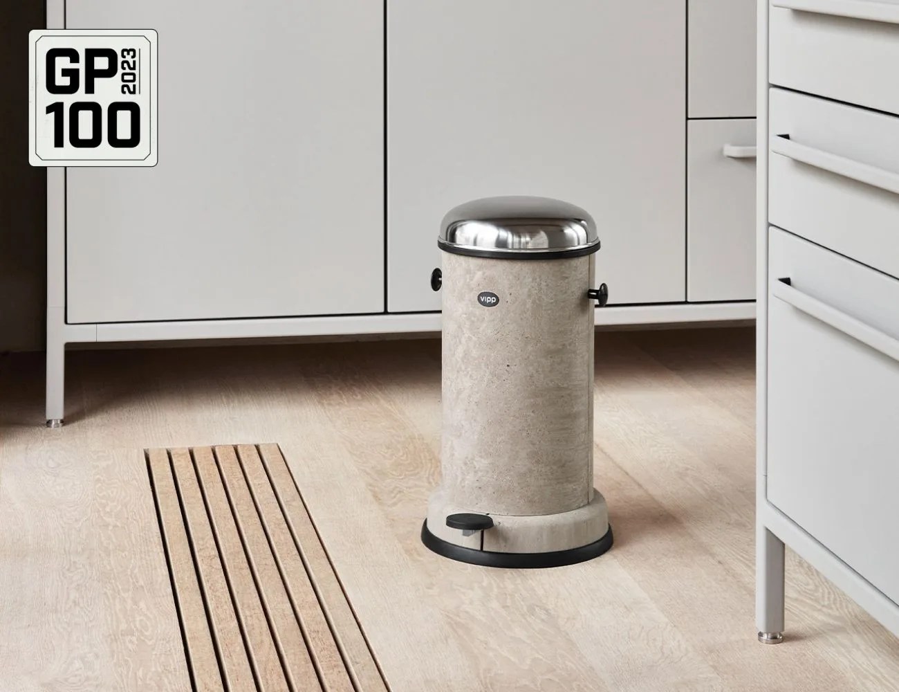a metal trash can in a room
