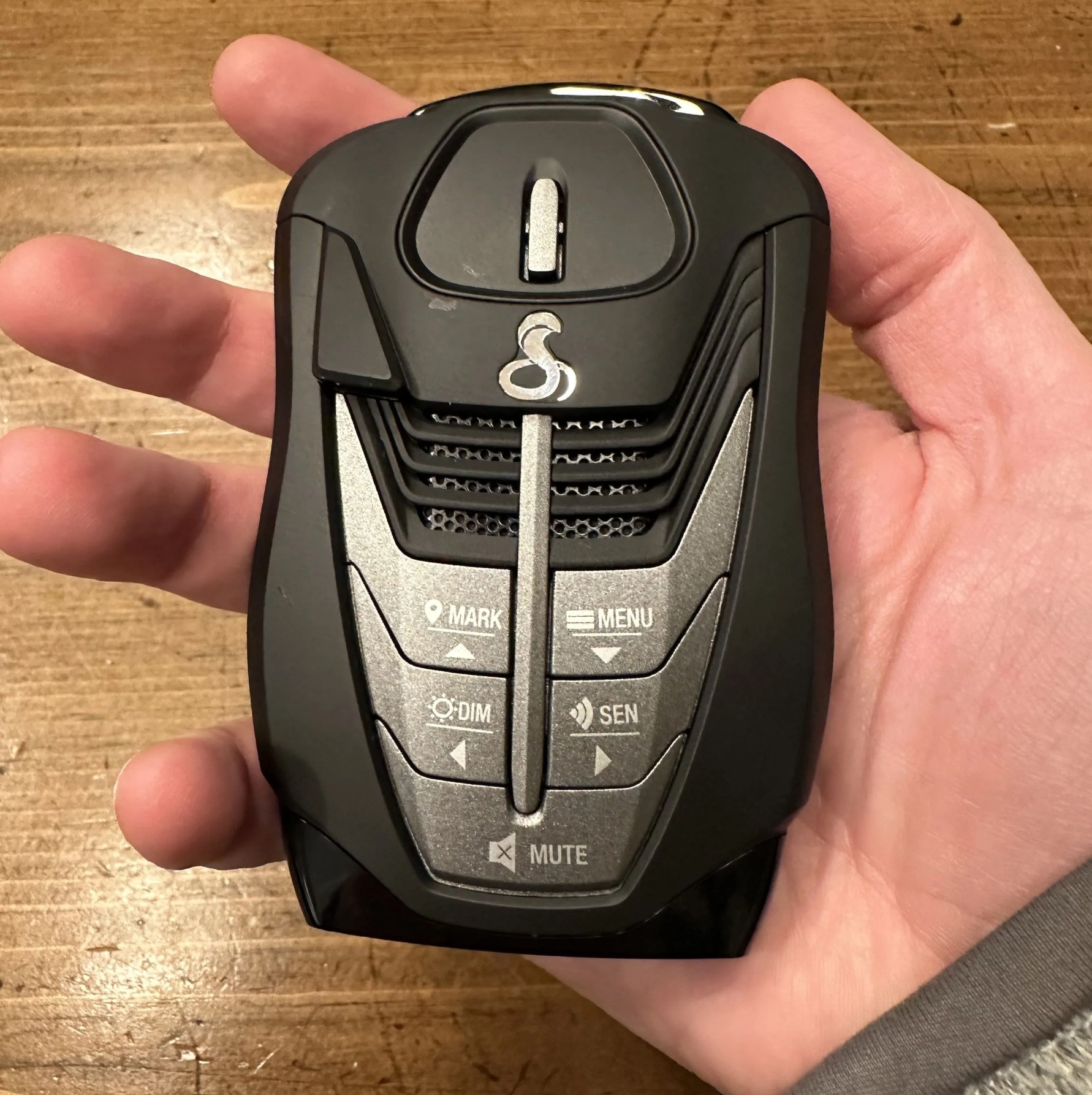 a hand holding a radar detector