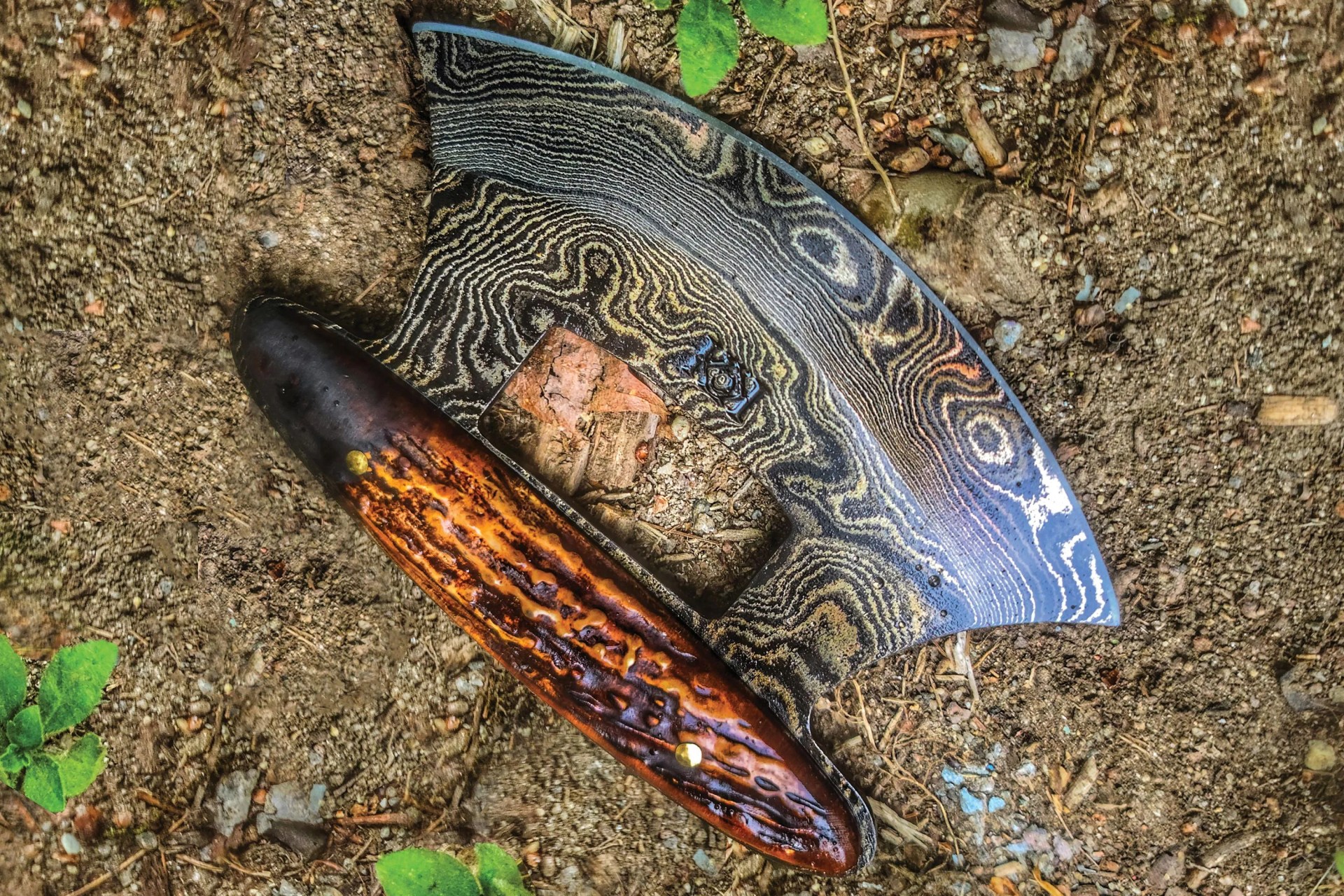 ulu knife with bone handle on the ground