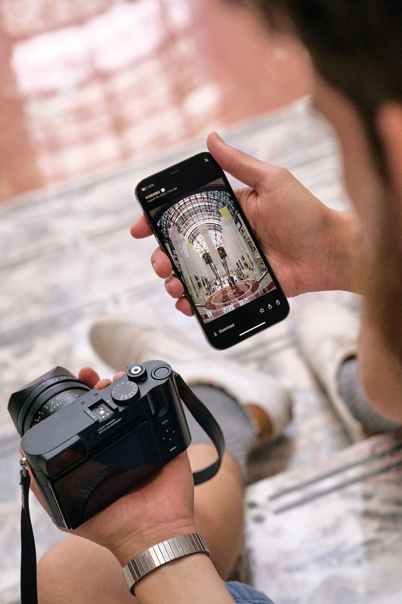 a man holding a camera and a phone