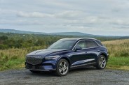 genesis electrified gv70 parked near a field